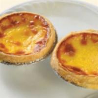 Baked Portuguese Egg Tart · Baked egg custard tarts in a flaky pastry crust. Contains dairy products.