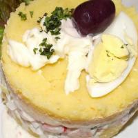 Causa Rellena con Camarones · Golden mashed potato fill with delicious creamy shrimp salad mayonnaise, cilantro, and celer...
