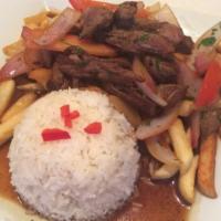 Lomo Saltado · Top sirloin strips saute with onions, tomatoes and a hint of vinegar and sillao (Peruvian so...