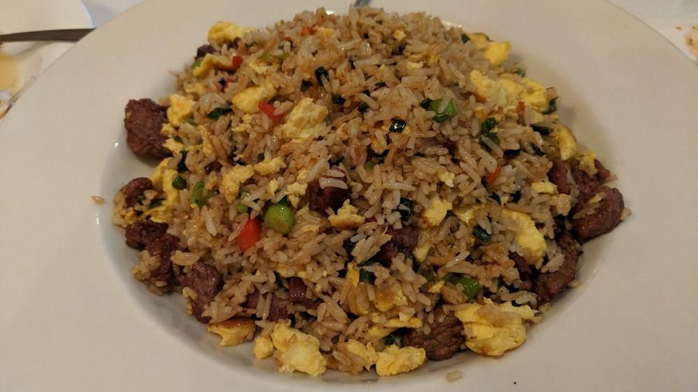 Arroz Chaufa De Carne · Peruvian style fried rice mixed with chopped beef, scramble eggs, green onions, red bell peppers and a hint of sillao (Peruvian soy sauce).