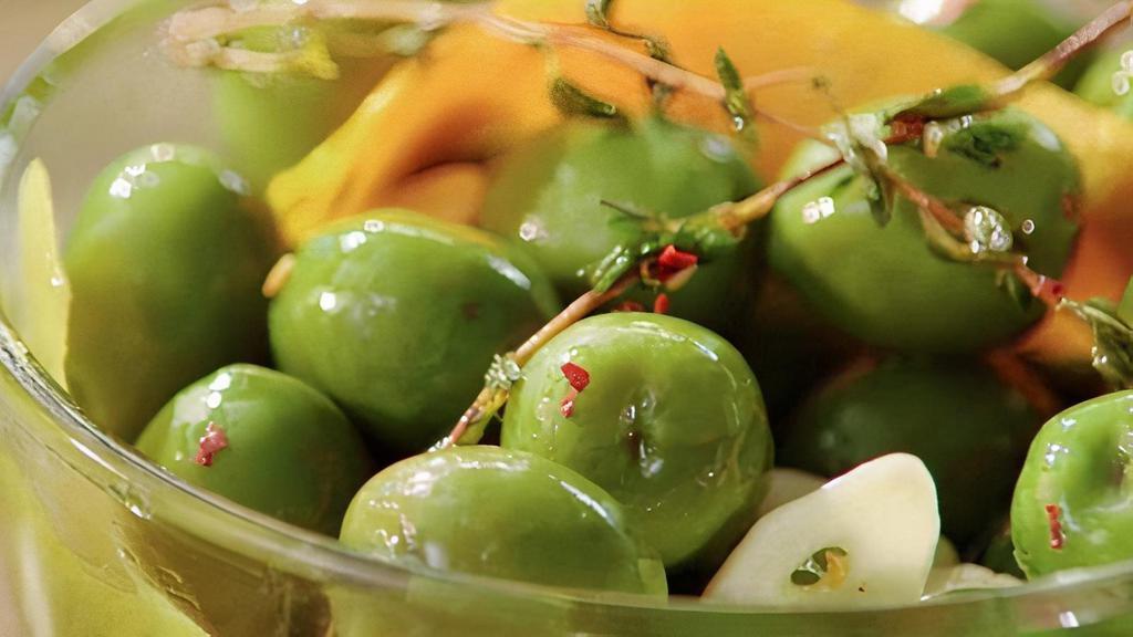 Marinated Olives · Citrus and chili flake marinated Castelvetrano olives.