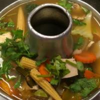 Tom Yum · Classic Thai spicy and sour soup simmered with lemongrass, kaffir lime leaves, galangal, mus...