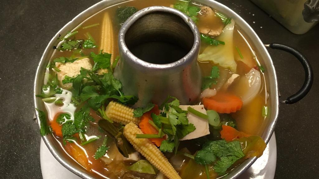 Tom Yum · Classic Thai spicy and sour soup simmered with lemongrass, kaffir lime leaves, galangal, mushroom, tomato, and onion.