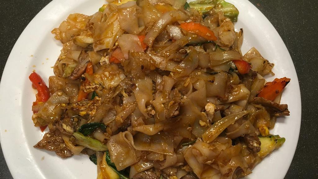 Pad Kee Mao (Drunken Noodles) · Medium Spicy .Pan fried rice noodle with your choice of meat, eggs, chili, onion, basil, bell pepper,cabbage, tomato and carrot.