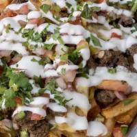Carne Asada Fries · Fries topped with cheese, steak, pico de dallo, cotija cheese, and sour cream, and carne asa...