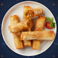 Chill In Spring Roll · Seasonal vegetables wrapped in rice wrapper and fried until golden crisp.