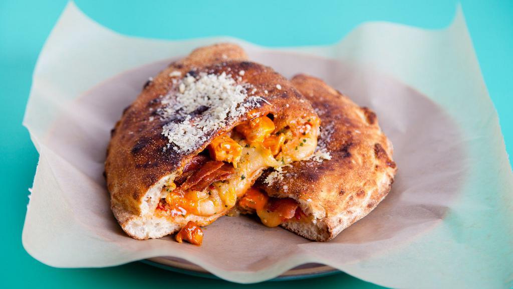 The Chicken Bacon Calzone · Delicious and freshly cooked calzone with mozzarella, ricotta, roasted chicken, and bacon.