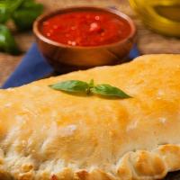 The Margherita Calzone · Delicious and freshly cooked calzone with mozzarella, ricotta, sliced tomatoes, and fresh ba...