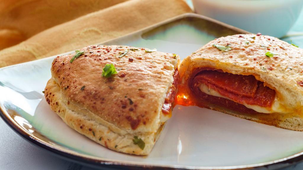Pepperoni Calzone · Delicious calzone fresh out of the oven, filled with pepperoni & ricotta and mozzarella cheese.