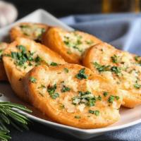 Garlic Bread with Melted Cheese · Fresh bread with melted cheese and marinara sauce.