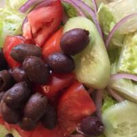 Greek Salad · Fresh lettuce with red onions, tomatoes, cucumbers, calamata olives and feta cheese with vin...