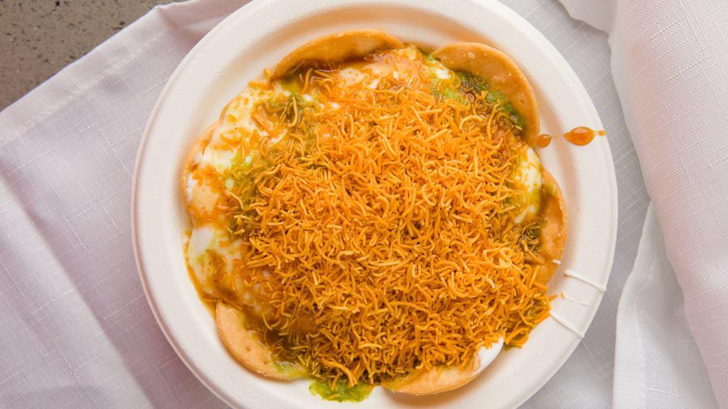 Dhai Papadi Chaat · Crispy wafers layered with potato sev, chutney and yogurt.