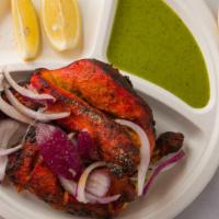 Tandoori Chicken (Half Chicken) · Tender chicken marinated in yogurt and spices, skewed in clay pot.
