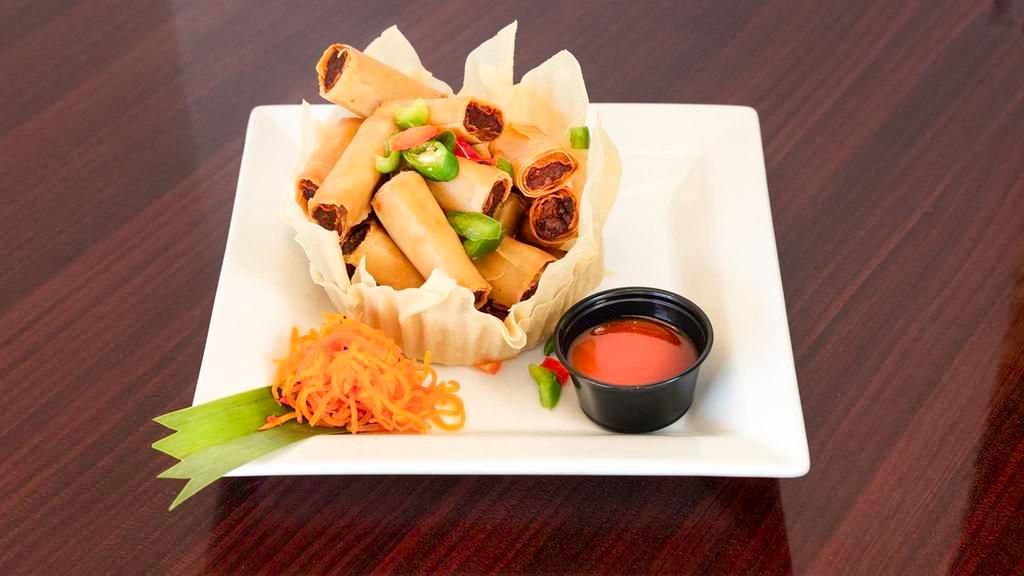 Lumpiang Shanghai (Egg Roll) · Contains egg. A filipino favorite. A delicious mix of ground pork and vegetables rolled in pastry wrapper and deep fried. Served with sweet and sour sauce on the side.