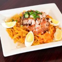 Pancit Palabok (Thick Rice Noodles) · Thick rice noodles in a delicious shrimp, squid, and ground pork sauce, garnished with garli...