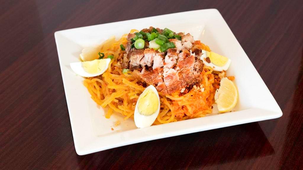 Pancit Palabok (Thick Rice Noodles) · Thick rice noodles in a delicious shrimp, squid, and ground pork sauce, garnished with garlic bits, ground pork cracklings, green onions, and sliced boiled egg. An all-time favorite.