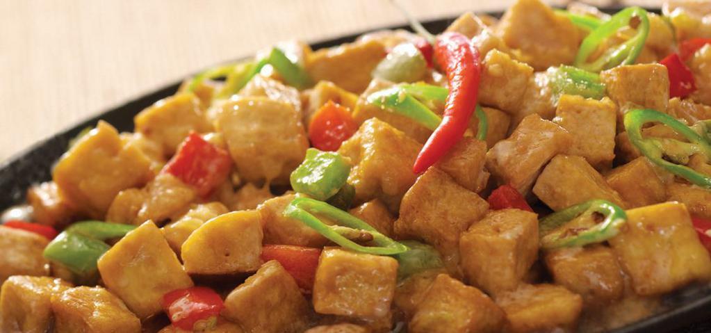 Tofu · Spicy. Tofu cubes with chopped onions and peppers glazed with a special sauce and topped with chili.