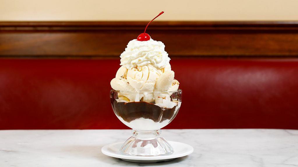 FUDGEANNA · Our handmade hot fudge sauce and a whole. banana layered in between two generous. scoops of ice cream. Served in a goblet that. is heaped with almonds, whipped cream. and a cherry.
