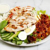 COBB SALAD · A timeless classic! Rows of chopped egg, crumbled bacon, avocado, crumbled blue cheese, toma...