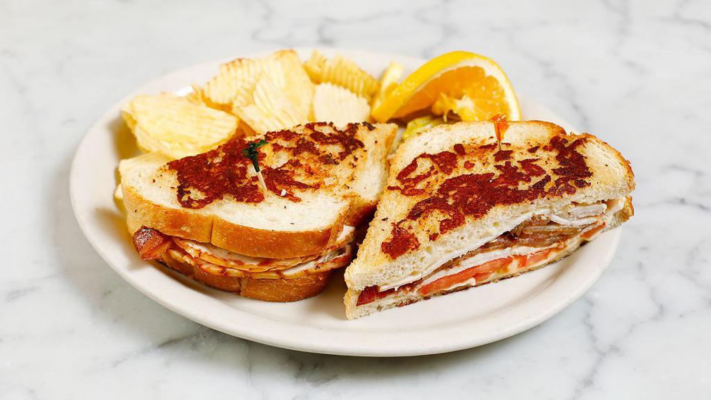 TURKEY BACON MELT · A mouthwatering Melt! Grilled sourdough. parmesan cheese bread with melted Swiss. cheese, turkey breast, crisp bacon,. tomatoes and mayo.
