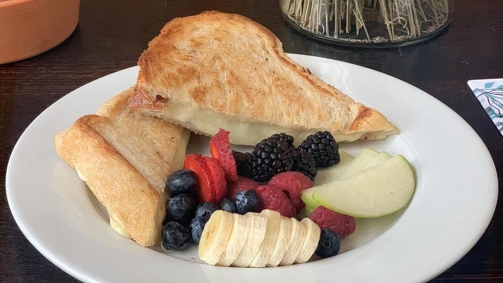 Grilled Cheese · Multigrain bread, mozzarella cheese served with seasonal fruit or garlic fries