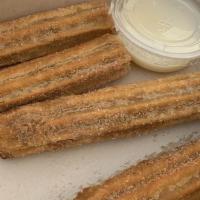 Churros · Two churros with cinnamon sugar and condensed milk
