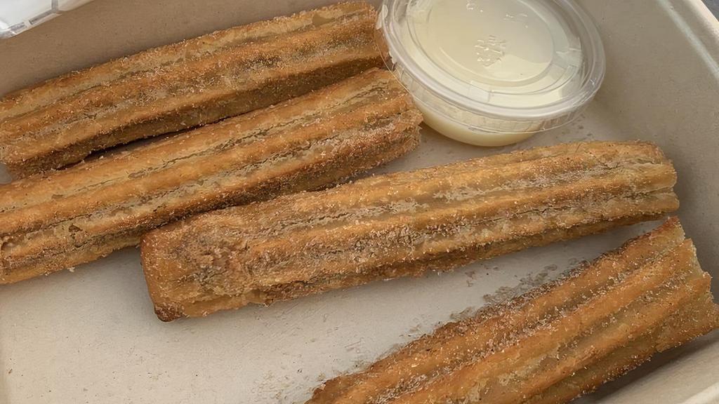 Churros · Two churros with cinnamon sugar and condensed milk
