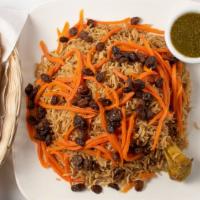 Quabili Pallow · Baked seasoned pallow rice prepared with tender lamb shank, topped with sautéed raisins, and...