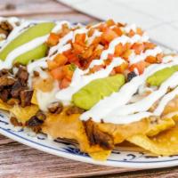 Nachos · Tortilla chips served with melted cheese, choice of beans, guacamole, sour cream, and fresh ...