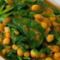 28. Spinach Garbanzo Curry/ Chana Saag · Fresh baby spinach, garbanzo and tomato cooked with spices in curry base.