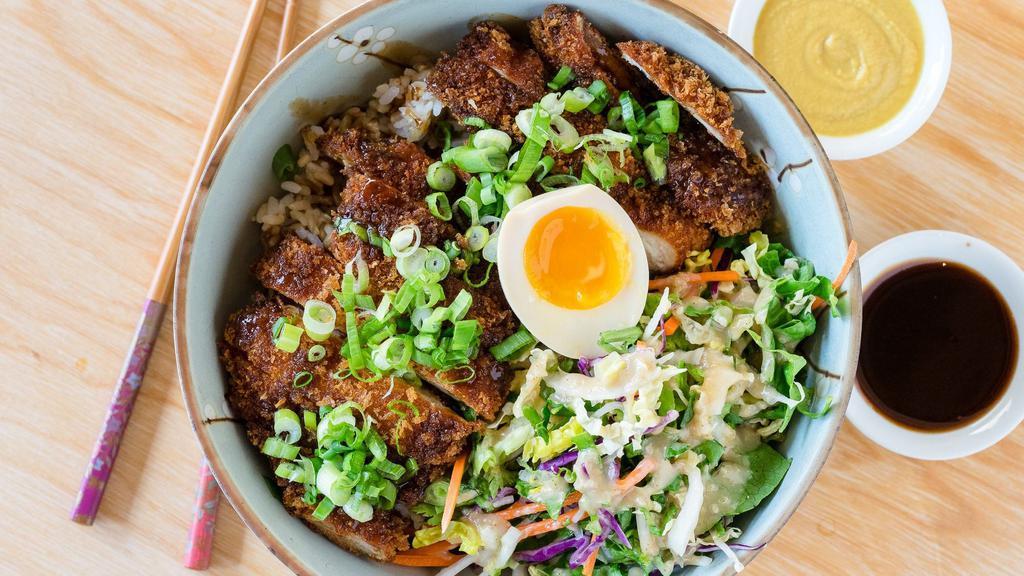 Chicken Katsu Donburi · Chicken Katsu rice bowl, salad with miso dressing, katsu sauce, green onion and half an egg.