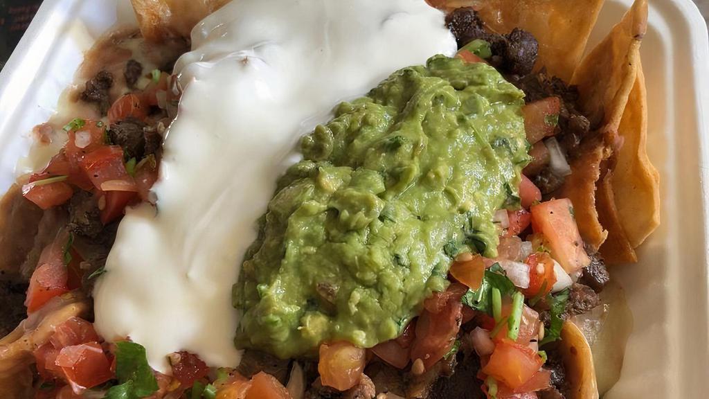 Super Taco · Meat, beans, salsa, guacamole, sour cream, and cheese.