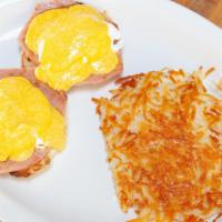 Eggs Benedict · English muffin topped with ham, poached eggs, and hollandaise sauce.
