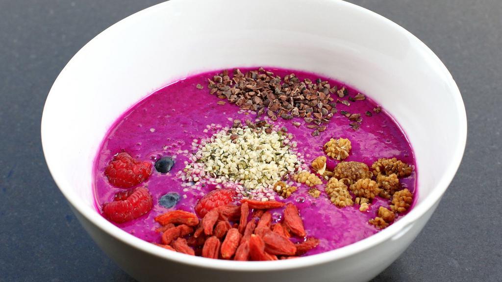 Jane's Dragonfruit Smoothie Bowl · Dragonfruit, pineapple, banana, ginger, coconut water, blueberries, raspberries, hemp seeds, flax seeds, cocoa nibs, goji, and mulberries.