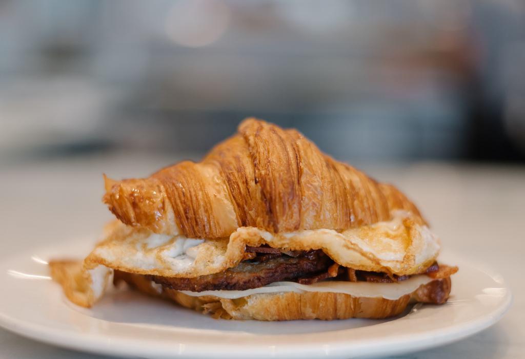Croissant Egg Sandwich · toasted croissant, ham, fried egg, caramelized onions, whole grain mustard, provolone