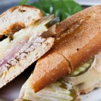 Classic Cubano Sandwich · Roasted pork, smoked ham, pickles, mustard and swiss cheese and salsa rosa.