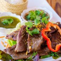Grilled Thai Steak · Grilled marinated beef with Thai spices & herbs served with Thai hot sauce, green salad, and...