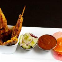 Chicken Satay · Grilled marinated chicken skewers served with cucumber salad and peanut sauce.