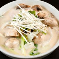 Tom Kha Gai · Coconut milk soup with slice chicken, Enoki mushroom, fresh mushroom, green onions, lemongra...