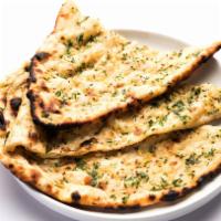 Garlic Naan · Flatbread sprinkled with crushed garlic, cheese and baked in tandoor oven.