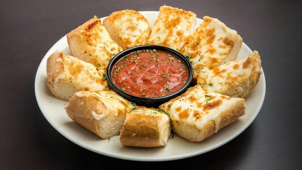 Sicilian Garlic Cheese Bread · A generous portion of fresh bread topped with a tasty blend of garlic and three melted cheeses served toasted with a side of our homemade Marinara Sauce.