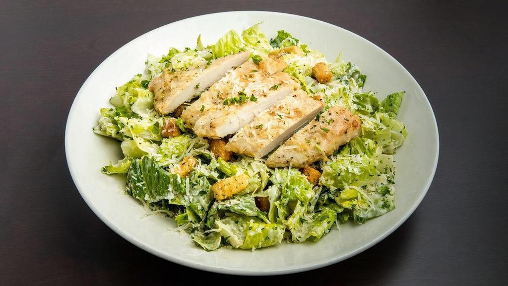 Chicken Caesar Salad · Lightly breaded chicken breast strips atop romaine lettuce tossed with Caesar dressing, shredded Romano cheese, and croutons.