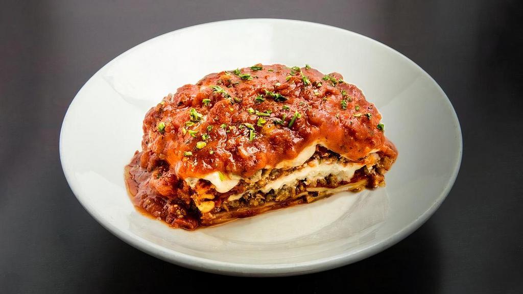 Our Famous Baked Lasagna · Layers of noodles, Marinara Sauce, ground beef and pork, and four delicious cheeses.