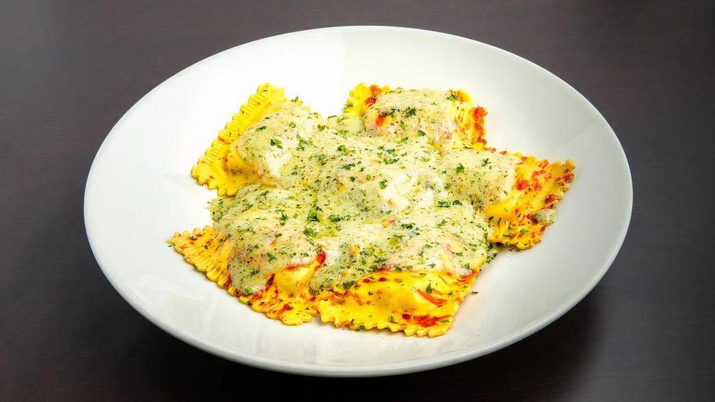 Gourmet Jumbo Crab Ravioli · Large ravioli stuffed with savory crab meat and ricotta cheese topped with a rich Pesto Alfredo Sauce.