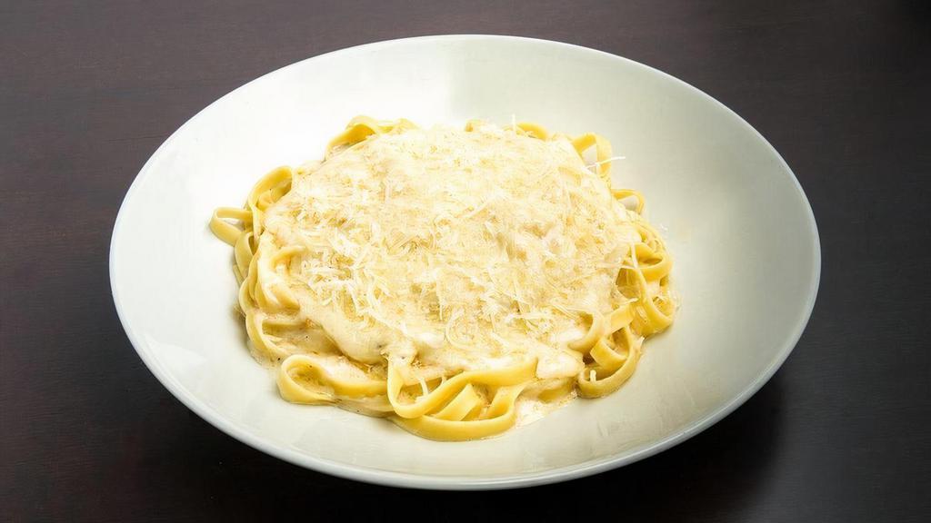 Fettuccine Alfredo · Fettuccine noodles in a butter cream sauce with shredded Romano cheese.
