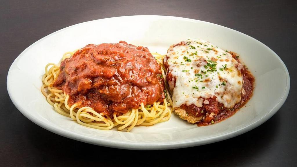 Chicken Parmigiana · A perfectly seasoned breast of tender chicken with melted cheese and Pomodoro Sauce. Served with spaghetti and Marinara Sauce.