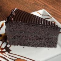 Chocolate Cake · Three layers of decadent chocolate cake filled and topped with creamy fudge frosting and gar...