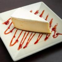 New York Cheesecake · A creamy cheesecake with a traditional graham cracker crust, garnished with a refreshing str...
