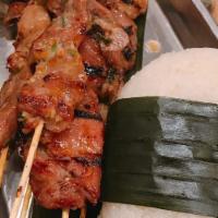 MOO PING SET · 4 GRILLED MARINATED PORK SKEWERS, STICKY RICE AND SPICY TAMARINE SAUCE.