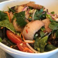 Yum Pork Jowl · Grilled pork jowl, red onion, green onion, mints leaves, roasted rice powder in spicy lime d...